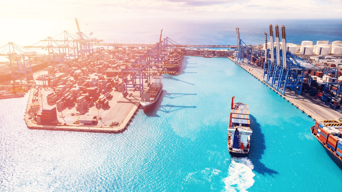 Aerial view of a container port terminal with gantry cranes where inbound shipments clear customs