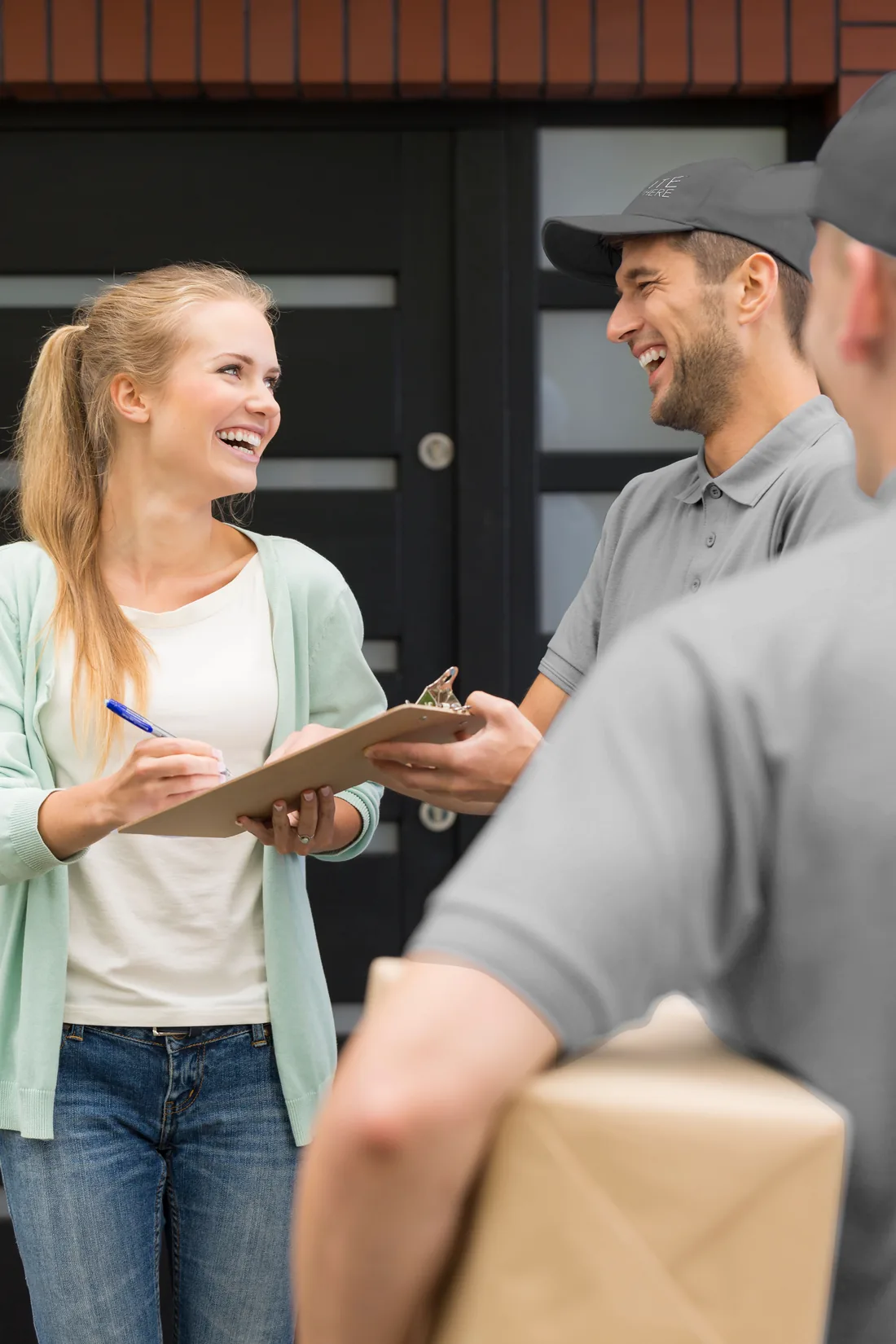 Elite Anywhere delivery — customer signing at the doorstep of an Austin home