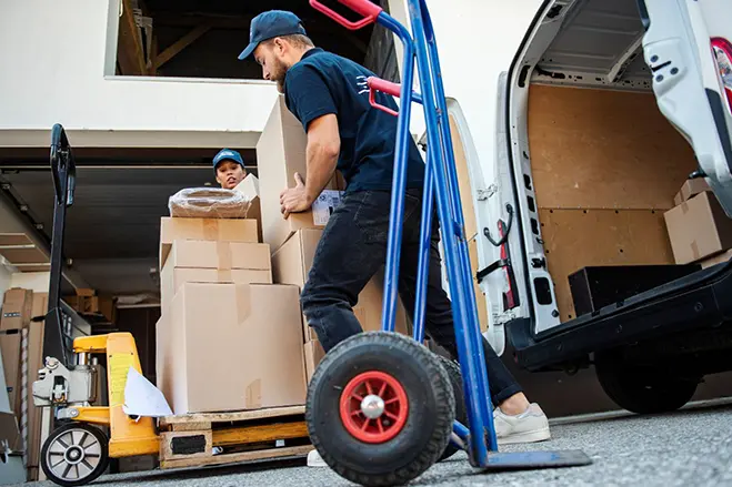 delivery men loading package on a trolley