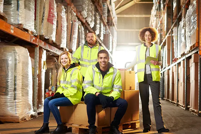 warehouse-workers-in-modern-warehouse-wearing-hi-vis-safety-clothing