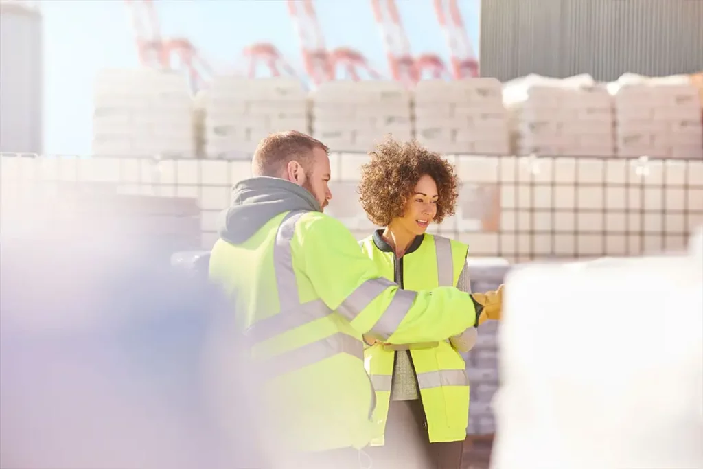 warehouse-workers-wearing-safety-vests-inspecting-packages