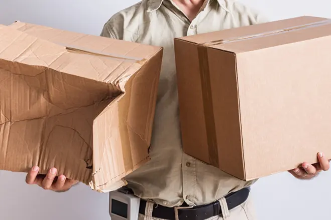 man-holding-damaged-delivery-boxes-after-delivery-elite-anywhere