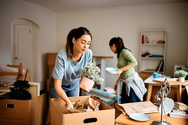 woman-packing-personal-belongings-in-a-brown-box